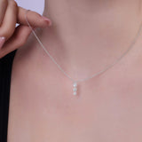 Floating Three-Stone Lab Diamond Pendant Necklace showcased on a model's neck, featuring three round lab-grown diamonds.
