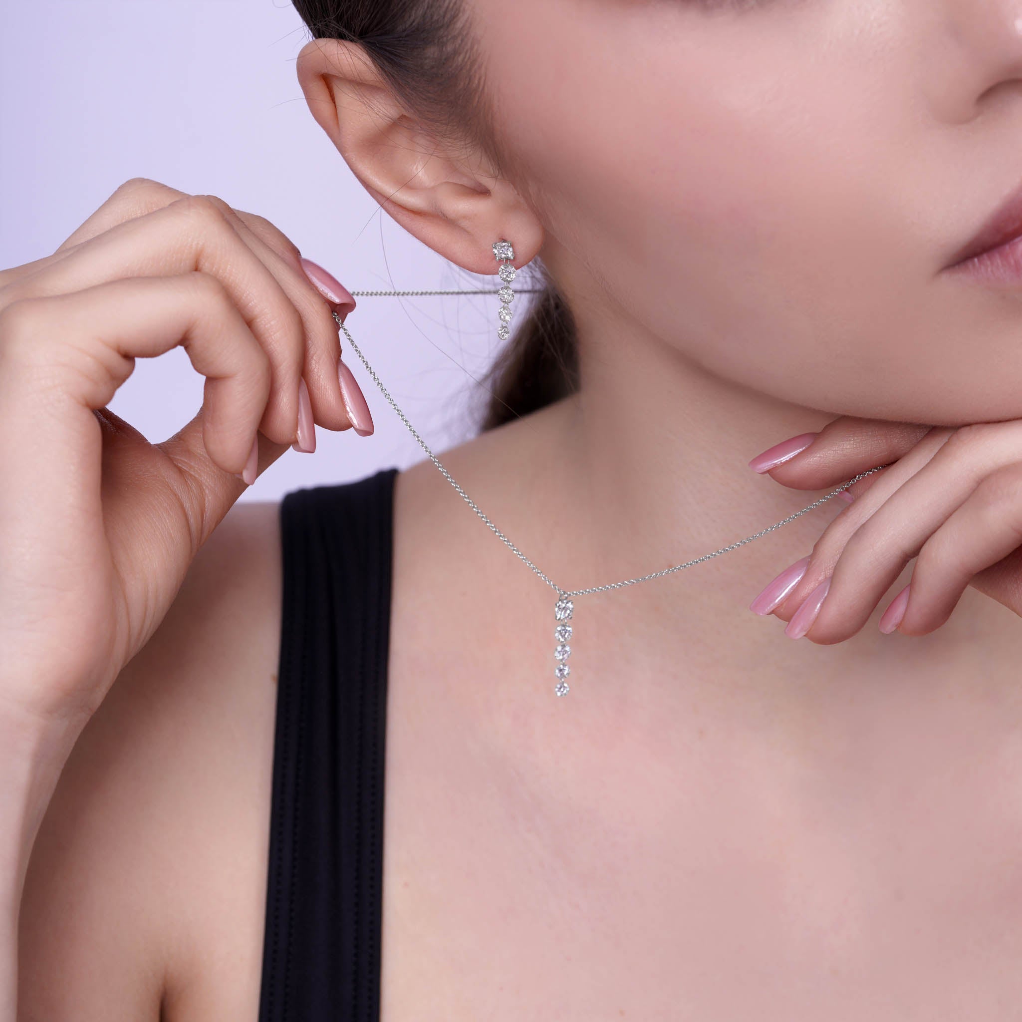 Floating Five-Stone Lab Diamond Pendant Necklace worn with matching earrings, showcasing elegance and style.