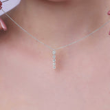 Floating Five-Stone Lab Diamond Pendant Necklace displayed on a model's neck, featuring five graduated diamonds in a sleek design.