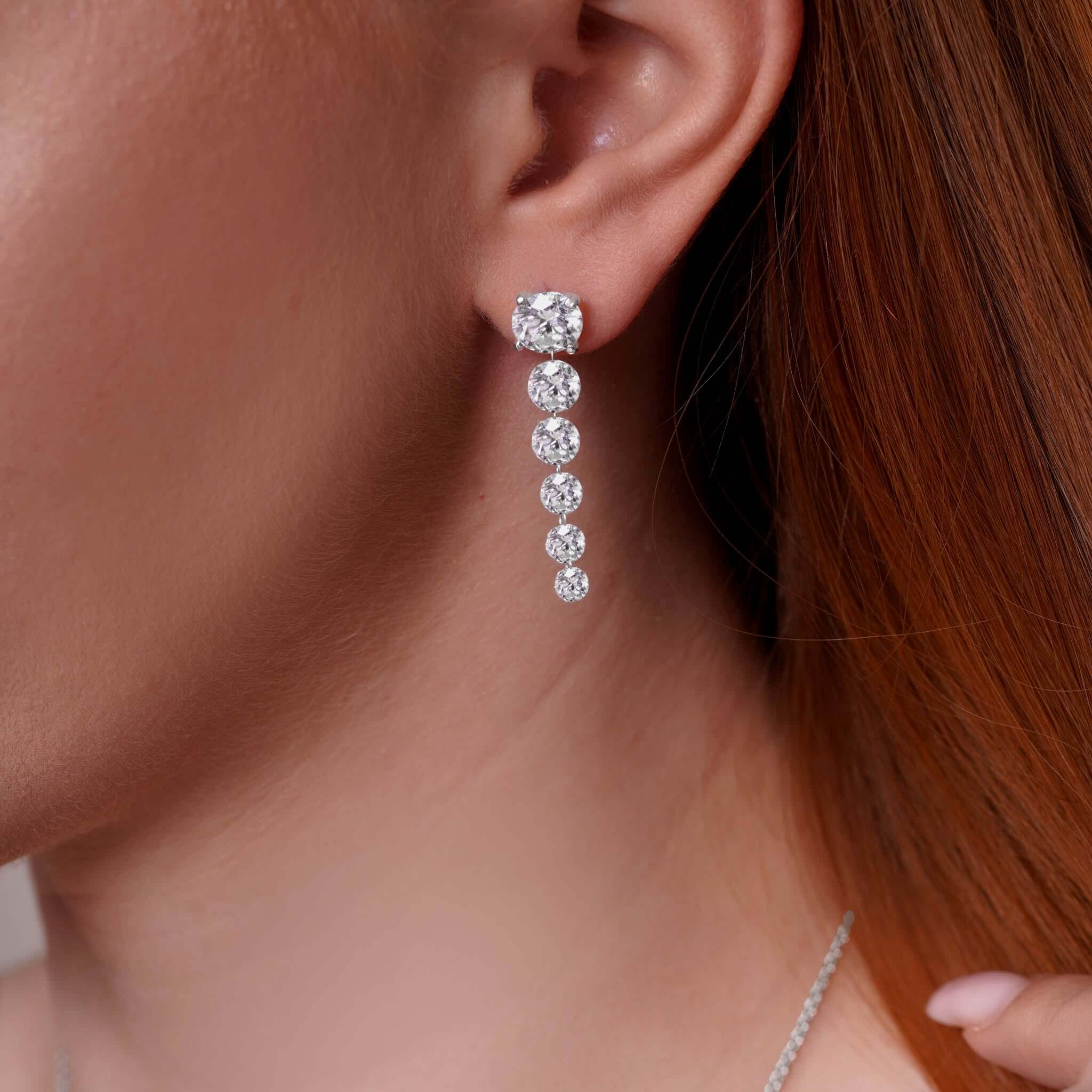 9 Carat Floating Lab Diamond Earrings on a model, showcasing brilliant sparkle and modern drop design.