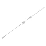 A delicate silver chain bracelet featuring a heart-shaped and infinity symbol charms, each adorned with tiny clear diamonds, displayed diagonally on a solid white background.