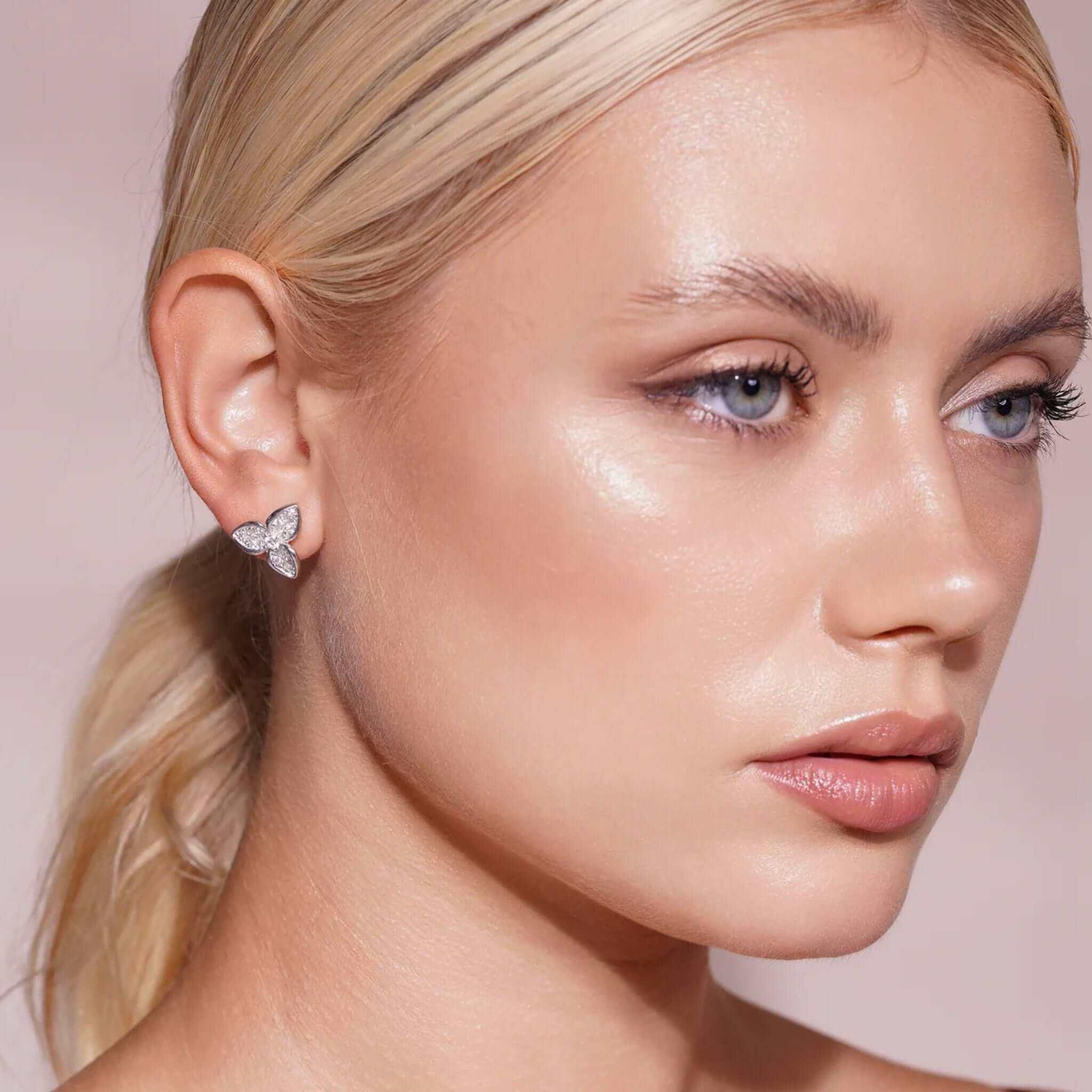 Lab Grown Diamond Three-Petal Pavé Flower Stud Earrings worn by a model with a soft glam look.