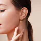 Model wearing Gold Endless Hoop Earrings, showcasing their timeless design and elegance.