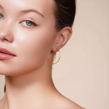 Model showcasing Gold Endless Hoop Earrings, highlighting timeless design and elegant style.