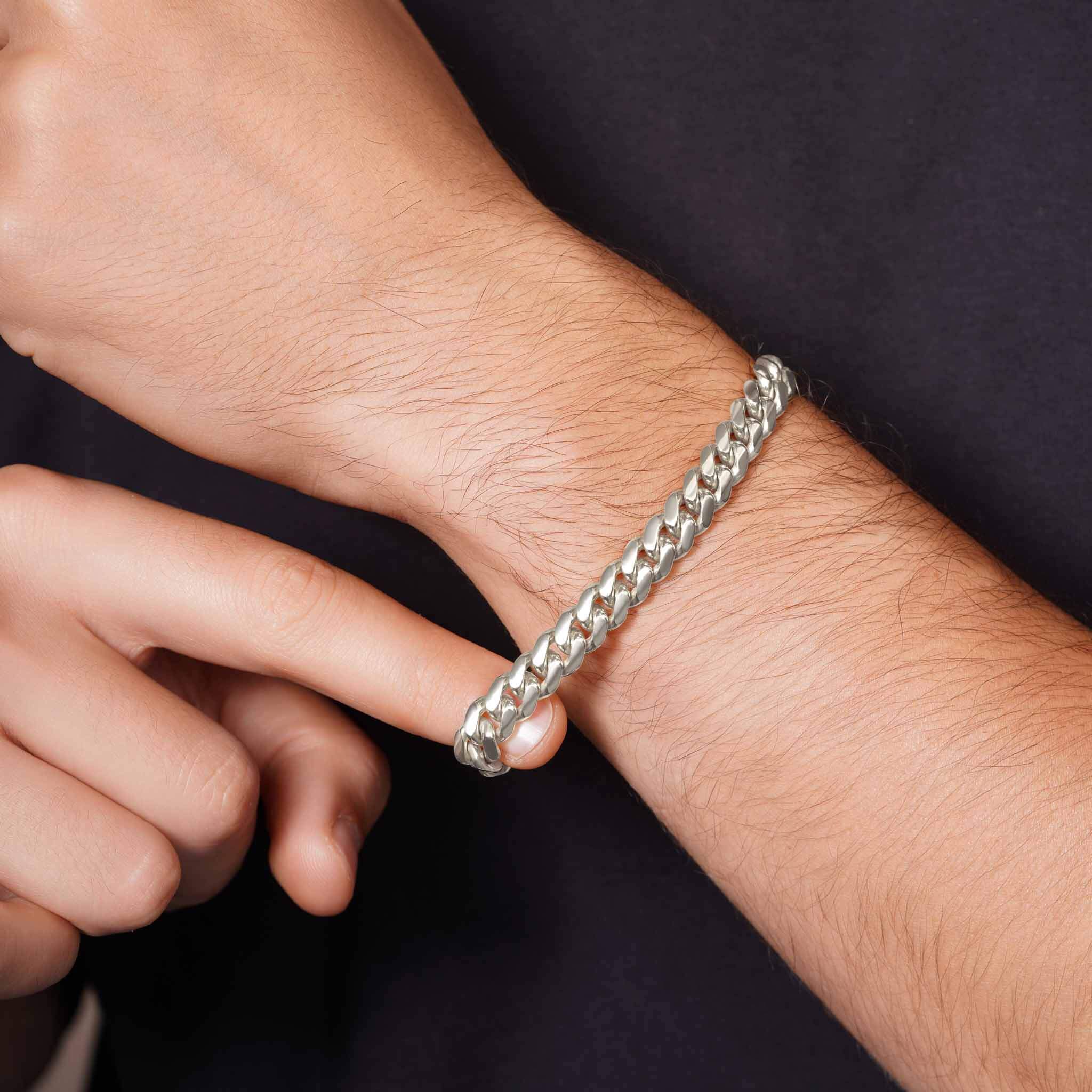 Men's Silver Miami Cuban Bracelet worn on a man's wrist, showcasing its sleek and polished design.