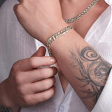 Men's solid gold curb bracelet in 14K gold, worn on wrist, showcasing classic design and expert craftsmanship.