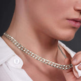 Close-up of a man wearing a solid gold curb chain, showcasing its bold and stylish design.