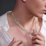 Close-up of a man wearing a sleek solid gold curb chain necklace, showcasing its elegance and shine.