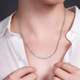 Men's solid gold curb chain necklace displayed on a man, showcasing its elegant design and shine.