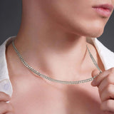 Close-up of a man wearing a silver curb chain necklace, showcasing its elegant design and craftsmanship.