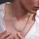 Men's solid gold curb chain resting on a man's neck, showcasing its sleek, interlocking links and shine.