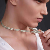 Close-up of a man wearing a silver curb chain necklace, showcasing its smooth interlocking links and elegant design.