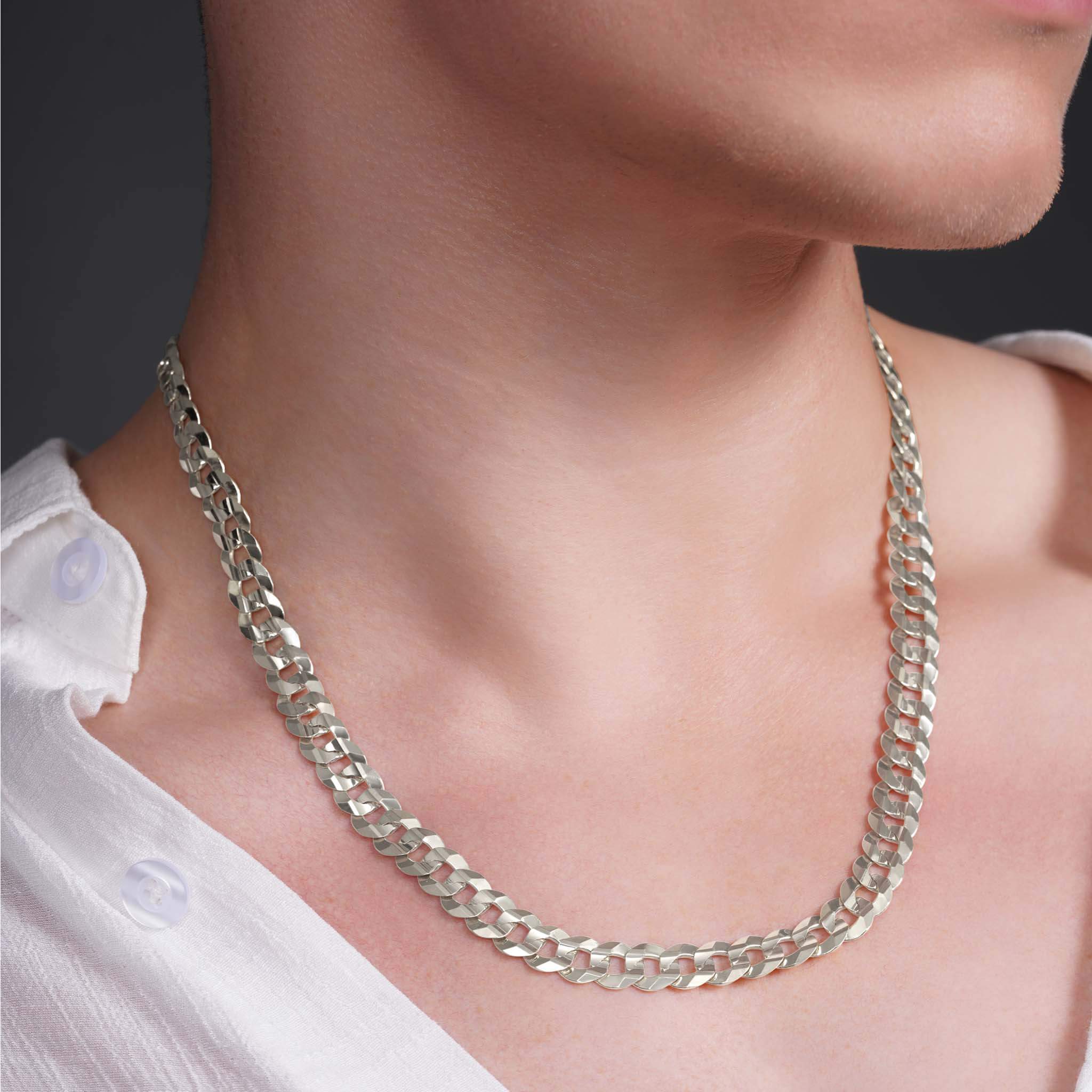 Men's solid gold curb chain necklace worn by a man, showcasing a stylish and bold design.
