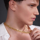 Close-up of a man wearing a shiny gold curb chain necklace, showcasing its smooth, interlocking links.