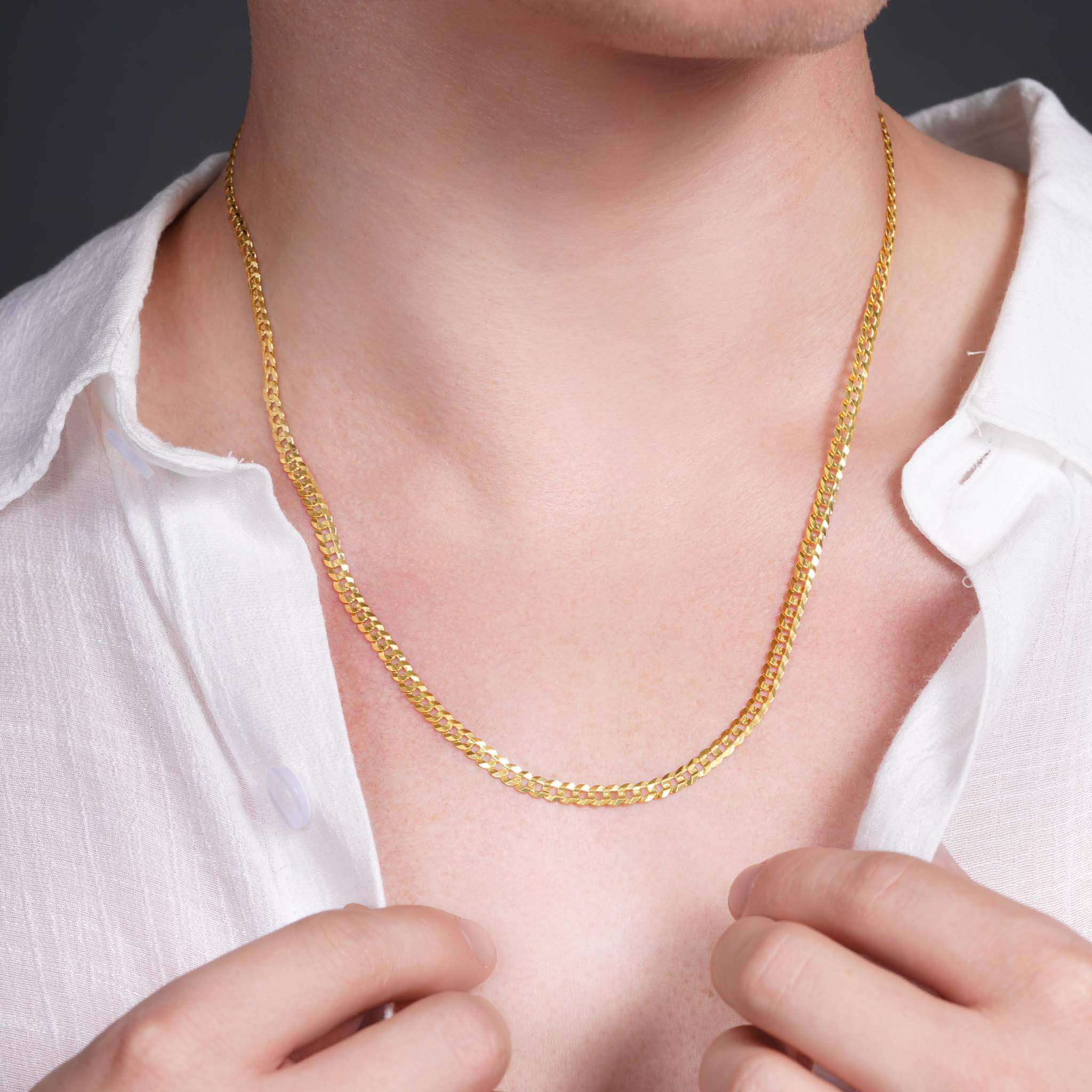 Men's solid gold curb chain necklace on a model, showcasing its elegance and timeless design.