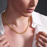 Men's solid gold curb chain worn on a model, showcasing its strength and timeless design.