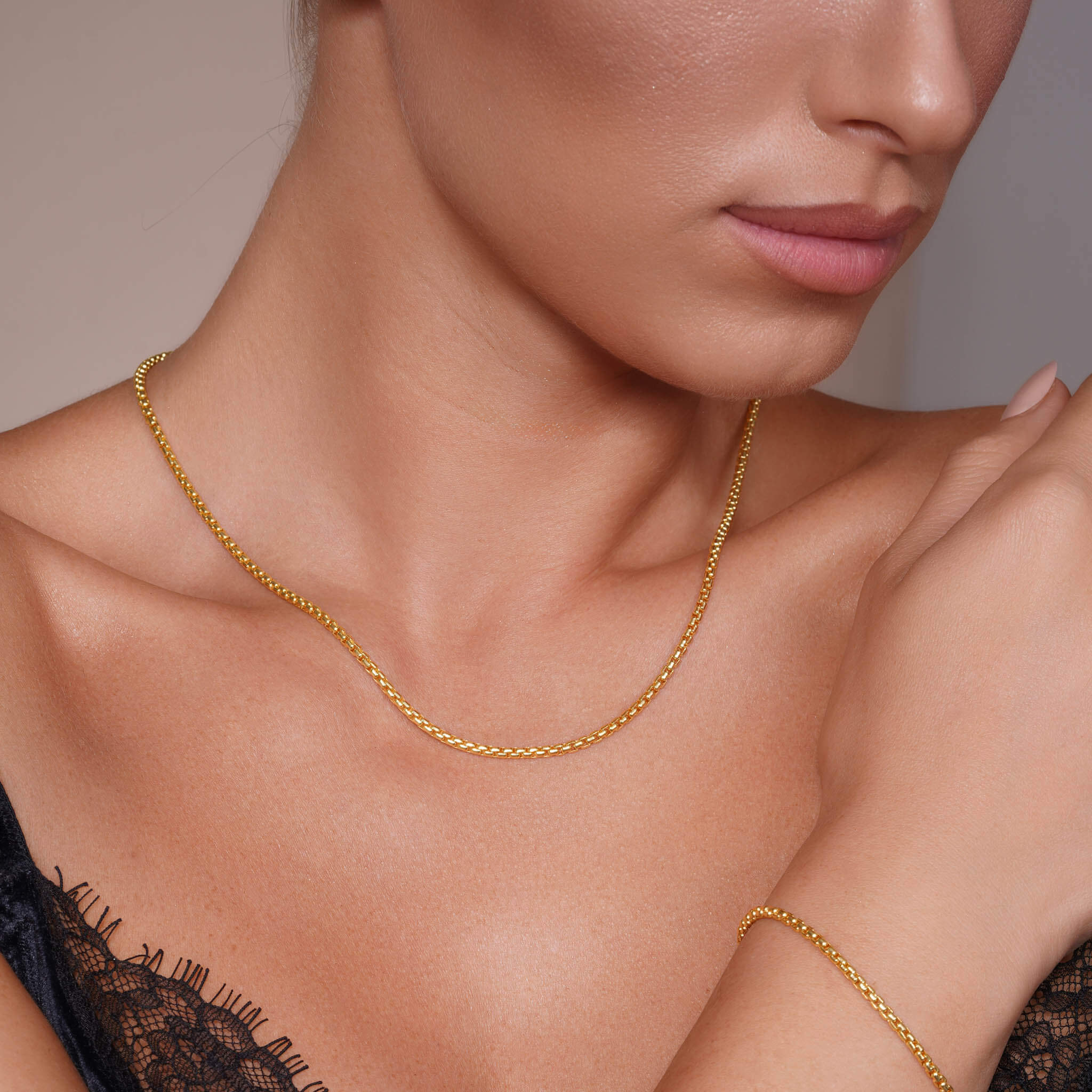 Round Box Chain worn by a model, showcasing its elegance in 14k yellow gold.