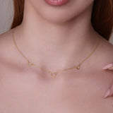 14k Gold Triple Heart Station Necklace showcasing delicate heart stations on a fine gold chain.