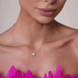 Round Moissanite Silver Pendant Necklace worn by a model, showcasing its brilliant 6.5mm moissanite stone and silver chain.