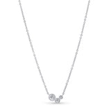 Silver necklace with three round pendants on a white background