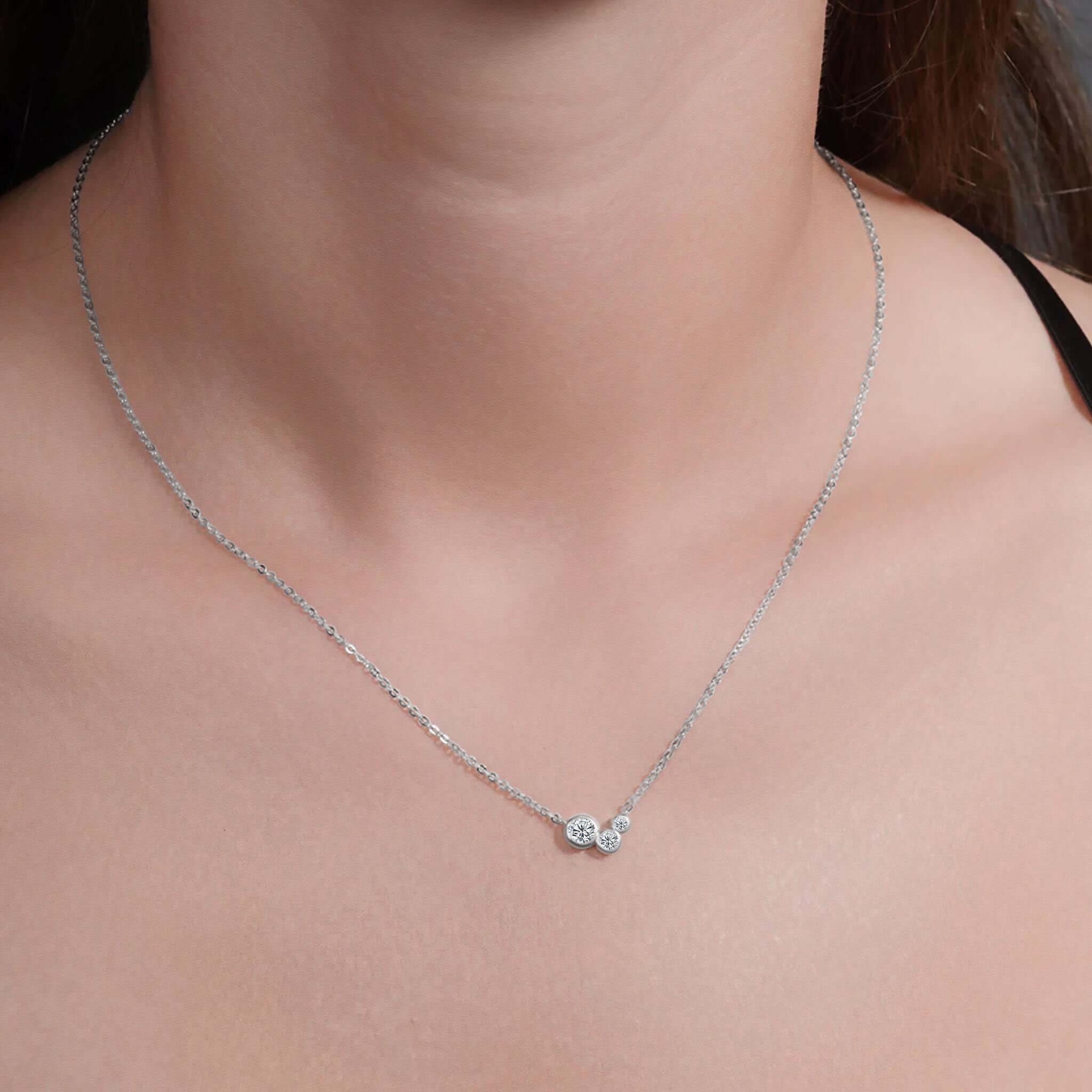Graduating Bezel Trio Moissanite Silver Pendant Necklace showcased on a model, highlighting its elegant design and sparkle.