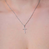 Elegant Cross Moissanite Silver Pendant Necklace worn on a delicate chain, showcasing its intricate design and brilliance.