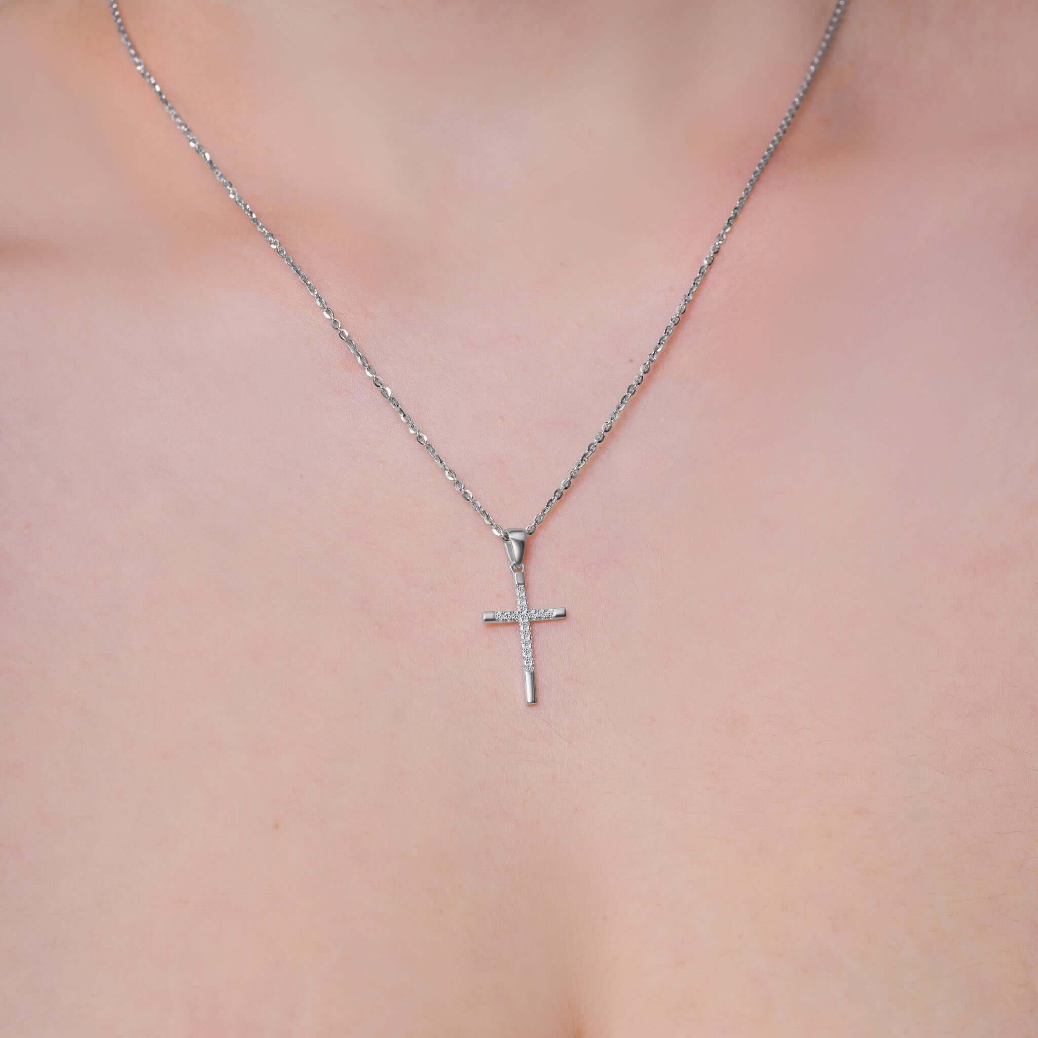 Elegant Cross Moissanite Silver Pendant Necklace worn on a delicate chain, showcasing its intricate design and brilliance.
