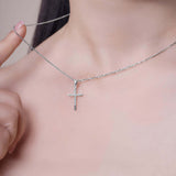Elegant Cross Moissanite Silver Pendant Necklace worn close-up, featuring a delicate cross design on a silver chain.