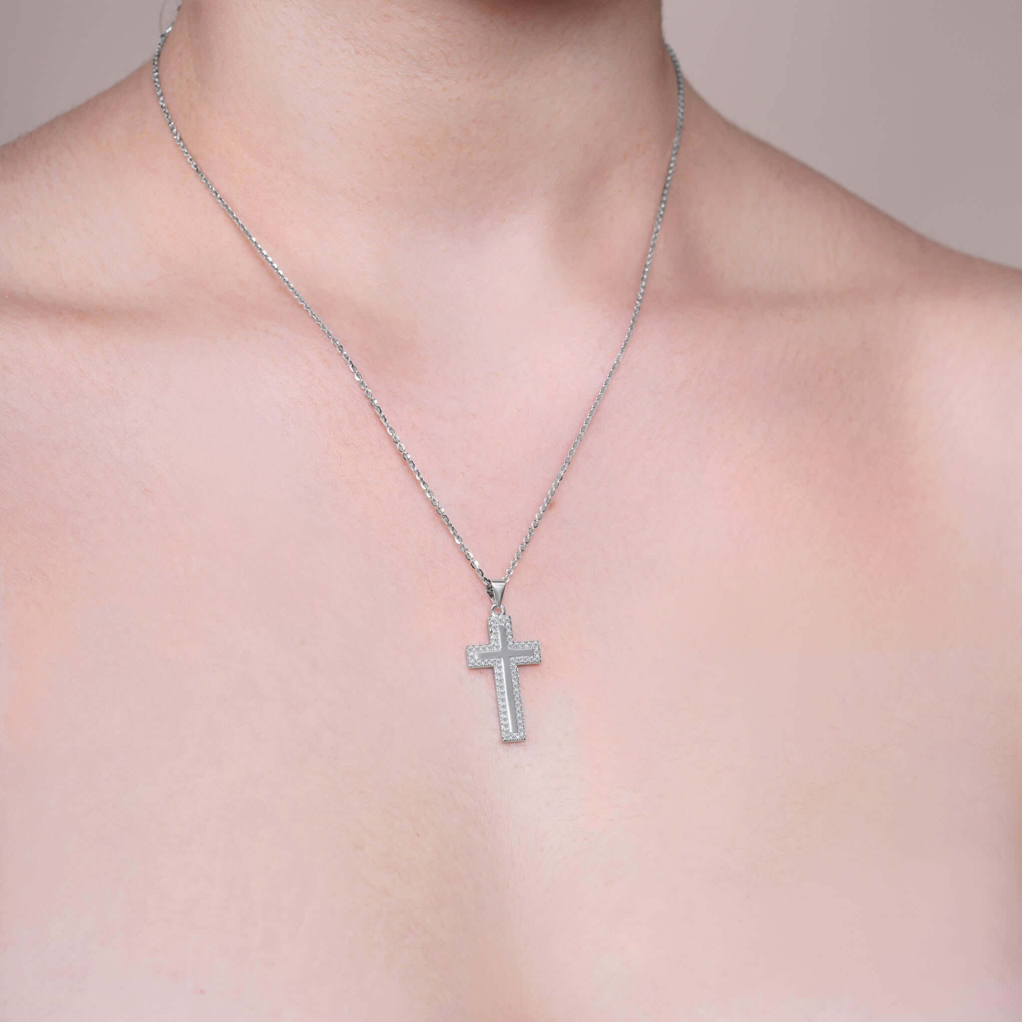 Framed Moissanite Cross Silver Pendant Necklace worn on a model, showcasing its exquisite design and brilliant sparkle.
