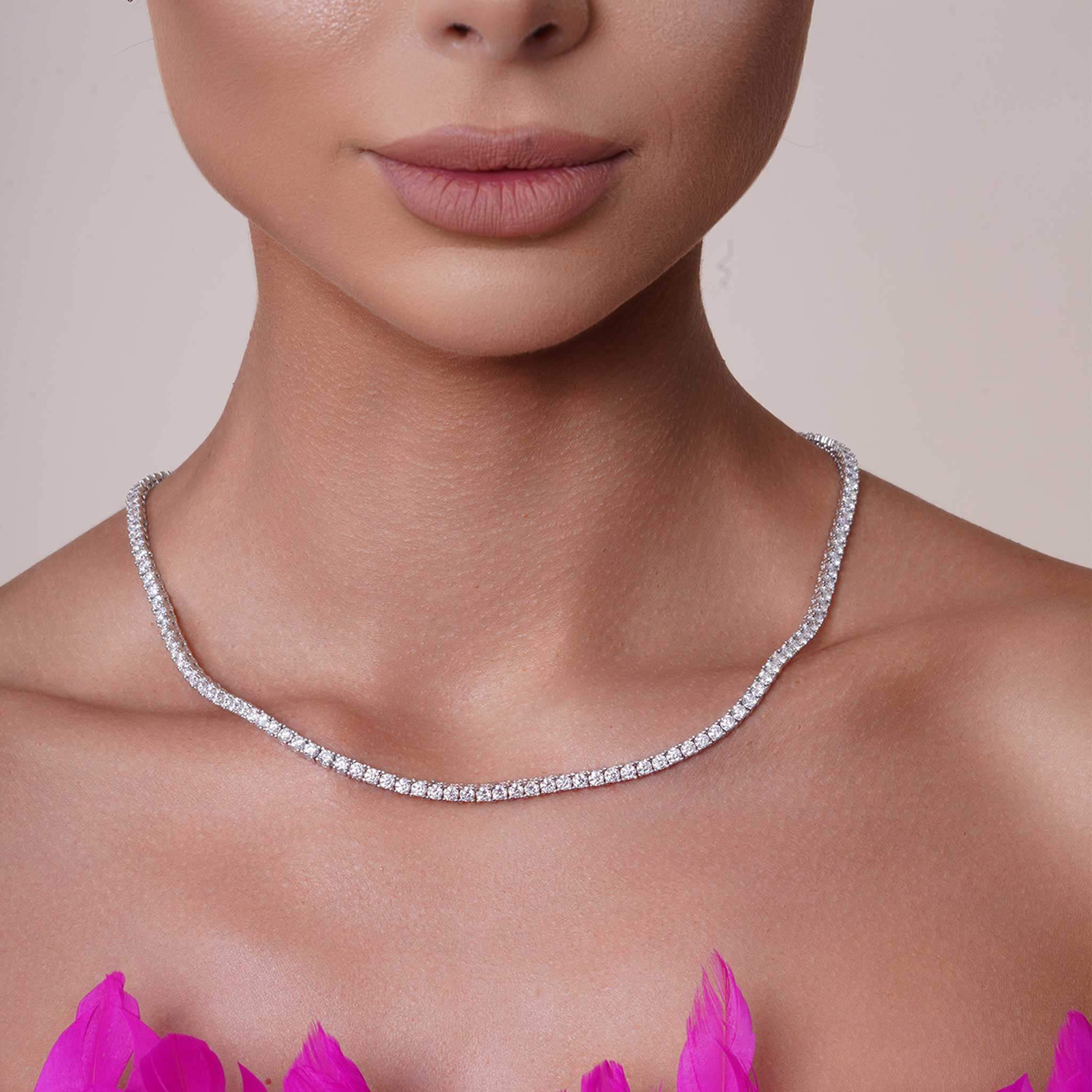 Silver moissanite necklace on a model with a neutral background