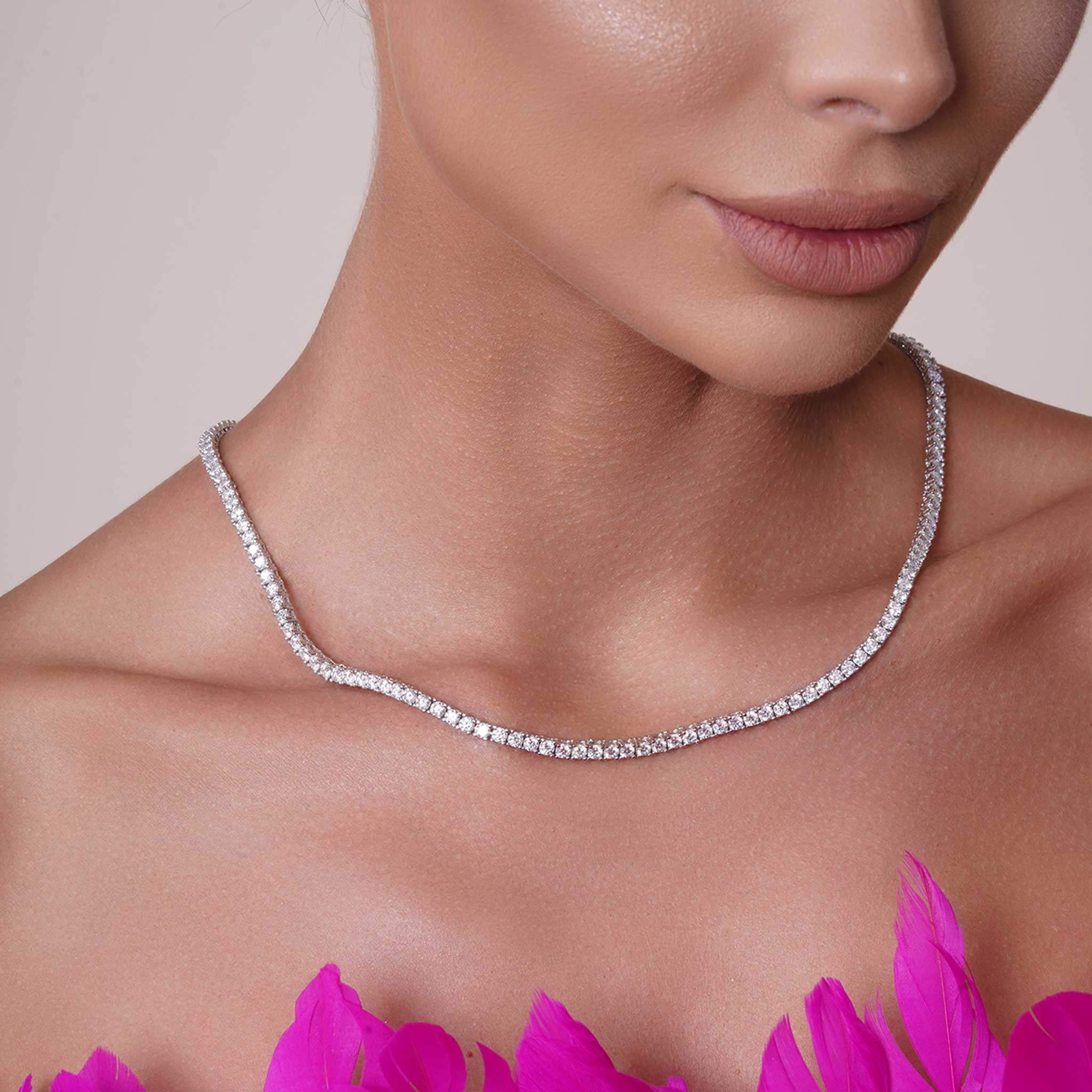 Round Moissanite Silver Necklace worn with a confident expression, showcasing its brilliance and elegance against a vibrant background.