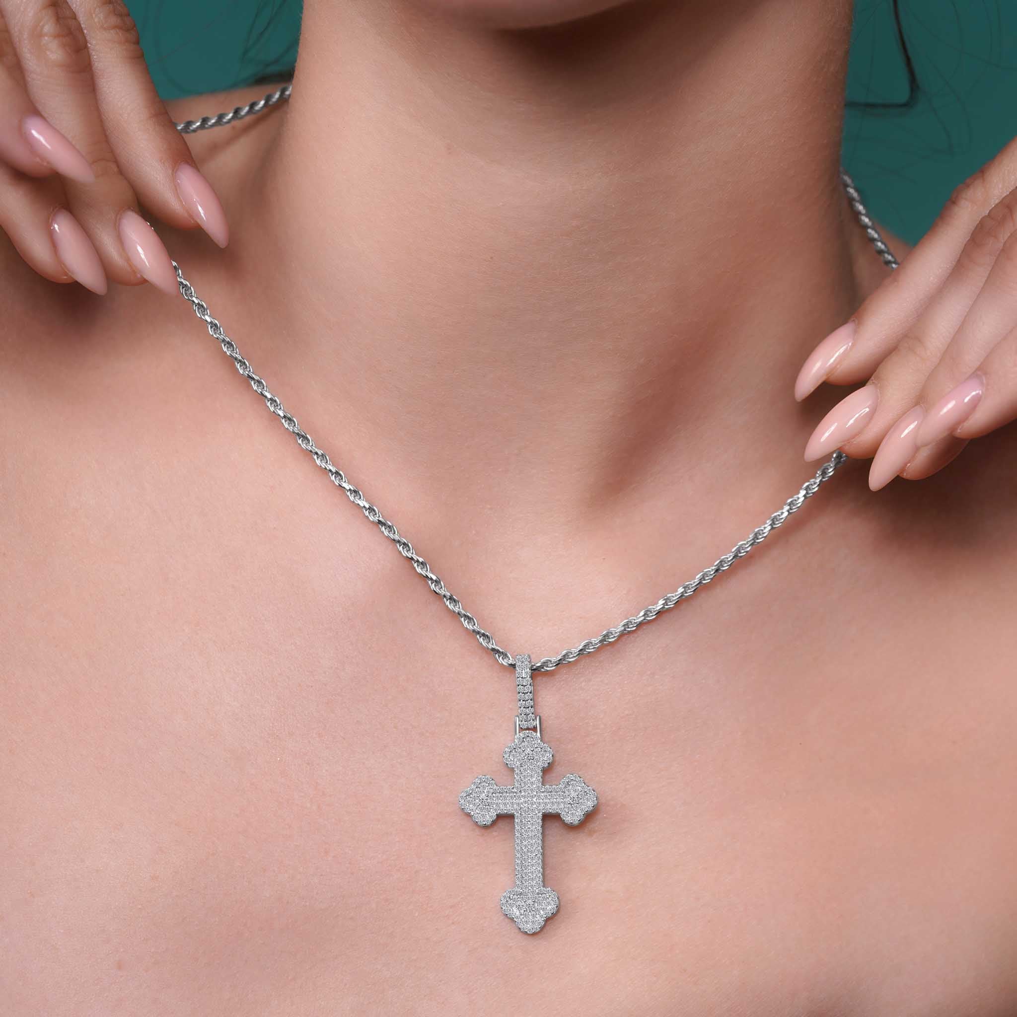 Silver Moissanite Budded Pavé Cross Pendant Necklace worn by a model, highlighting its shine and intricate design.