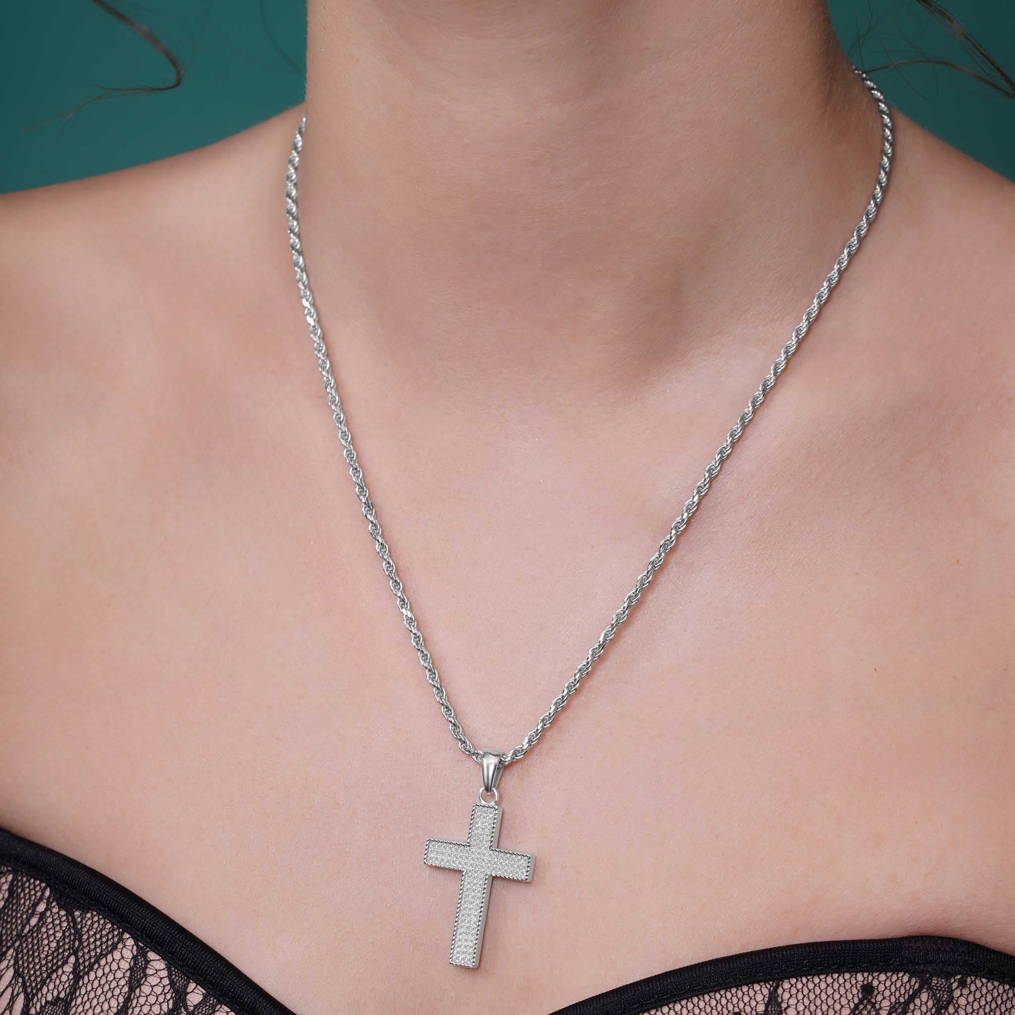 Silver Moissanite Pavé Milgrain Cross Pendant Necklace displayed on a model's neck with silver rope chain.