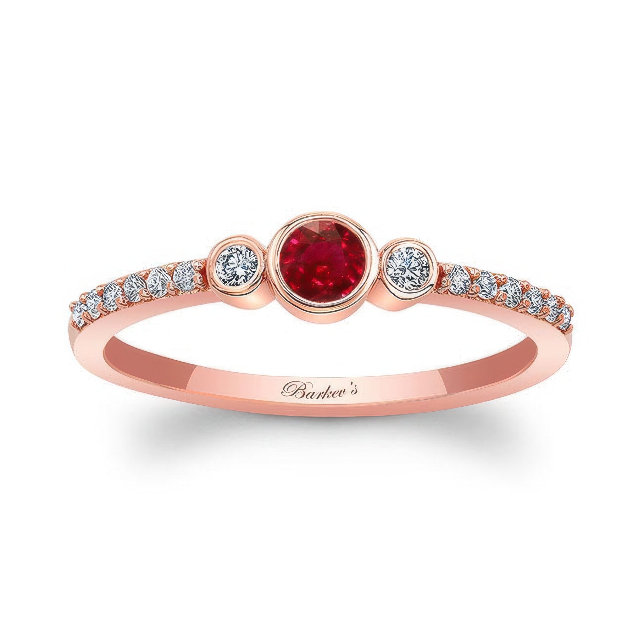 Mia Ruby three stone diamond promise ring featuring a ruby center and two bezel set diamonds, set in rose gold.