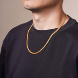 Men's Vermeil Miami Cuban Chain worn by a man showcasing its luxurious design and golden hue.