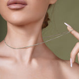 Close-up of a woman wearing a Franco Silver Chain, showcasing its elegant and polished design.