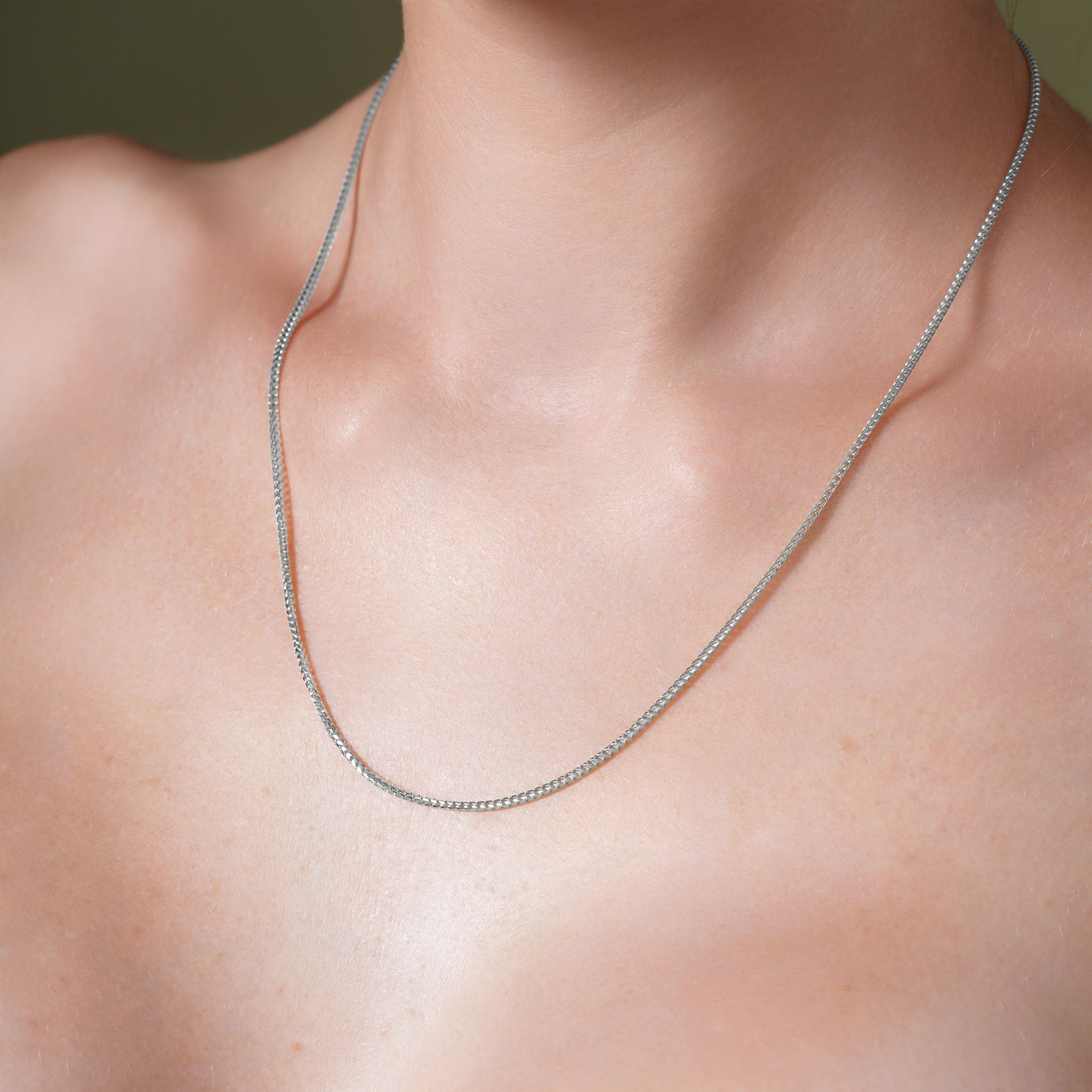 Franco Silver Chain worn on a model's neck, showcasing its elegant design and polished finish.